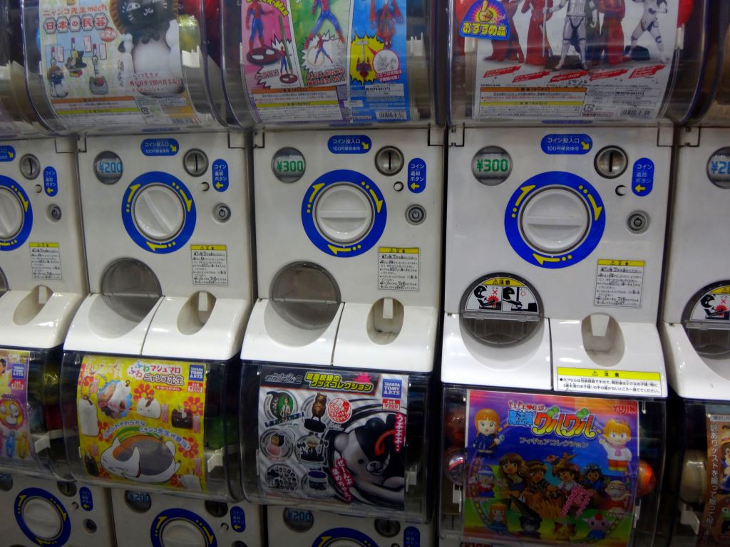 A row of white Gachapon machines filled with capsule toys in Akihabara