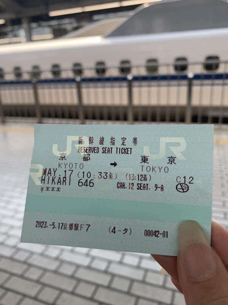 Hand holding Shinkansen ticket in Japan