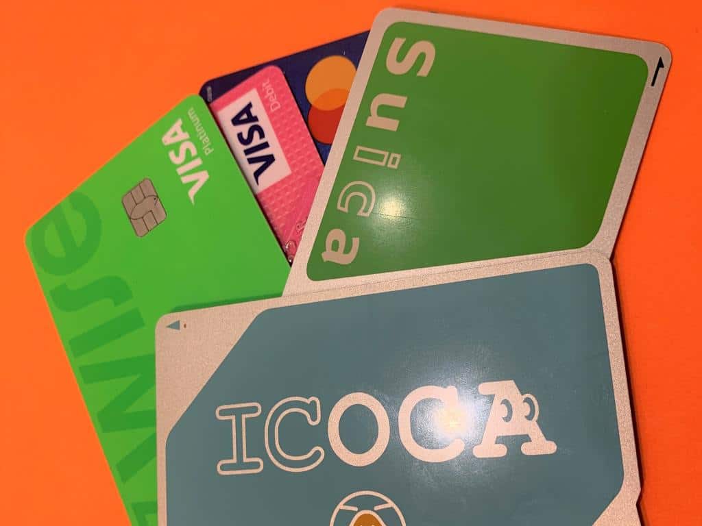 a selection of credit cards and Japanese IC cards on an orange background