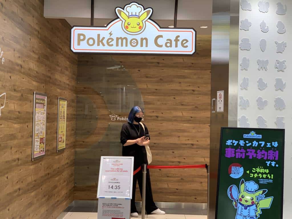 Exterior shot of the Pokemon cafe showing a sign saying Pokemon Cafe with Pikachi wearing a chef's hat
