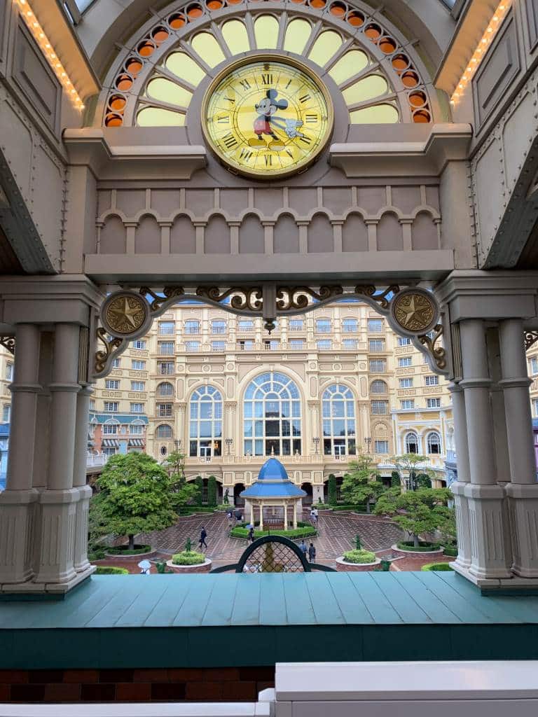 Image of Tokyo Disneyland Hotel taken from the monorail platform. A Mickey Mouse clock is in the foreground.