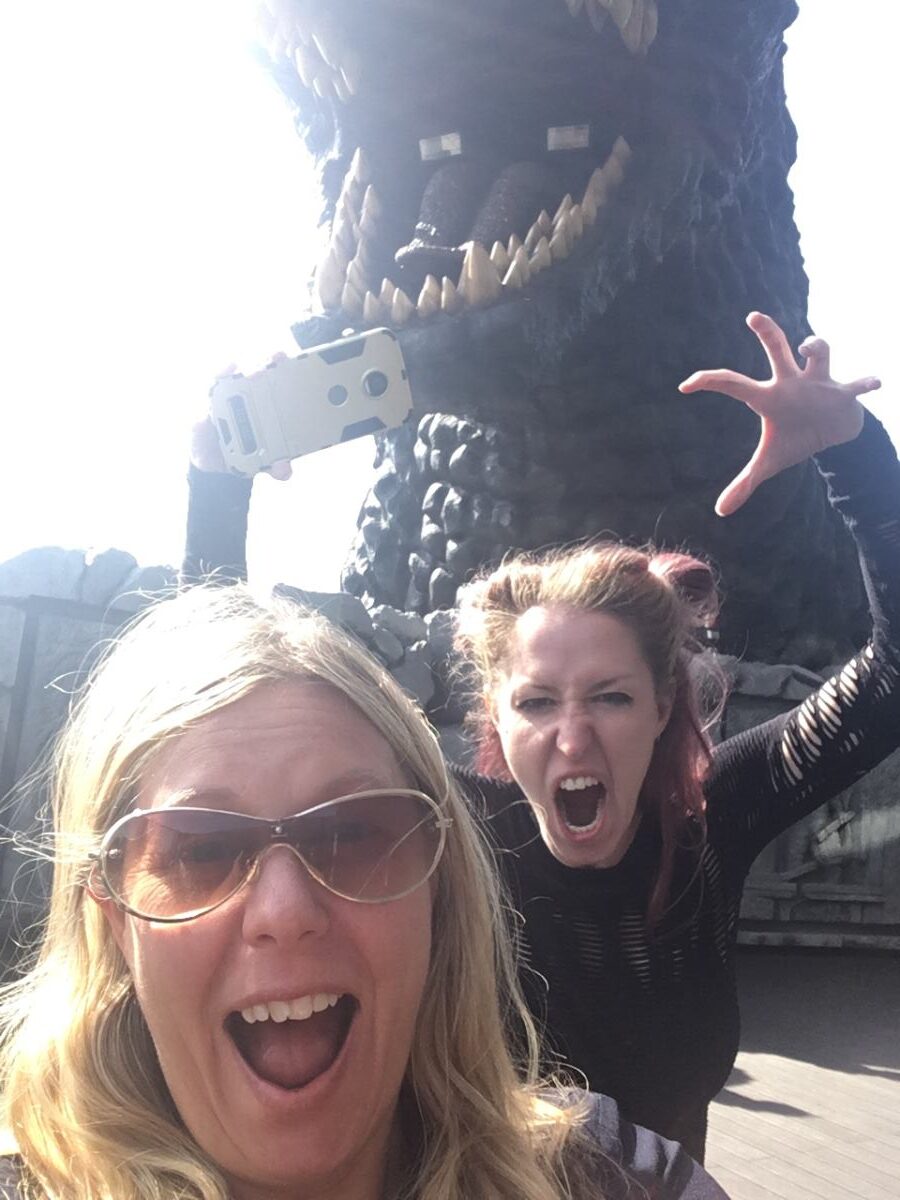 Helen from Japlanease stands next to the Godzilla head in Shinjuku - screaming!