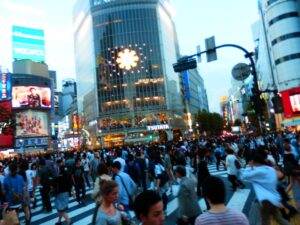 Hundreds of people cross Shibuya Crossing at night