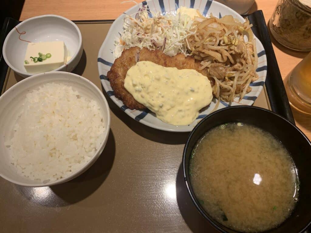 Set meal containing Tonkatsu cutlet, pork and ginger and cabbage with rice and miso