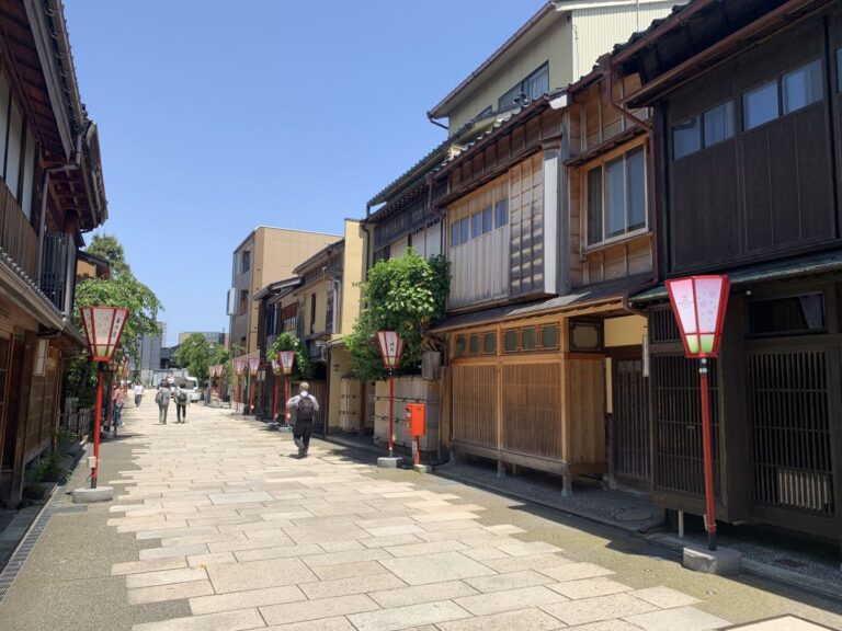 View of Nishi Chaya main street in Kanazawa showing old wooden houses and red framed old fashioned lights