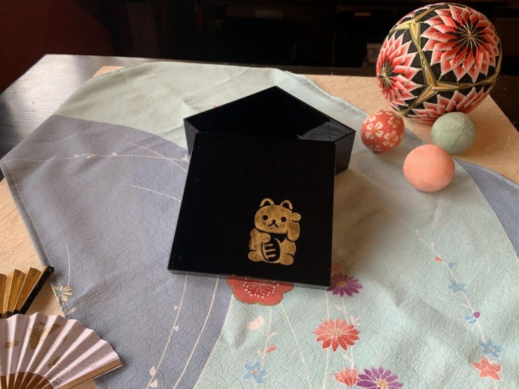 Small black box with a gold leaf waving cat added to it at the Gold Leaf Experience in Kanazawa