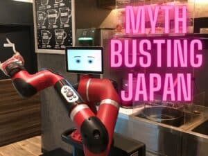 Coffee making robot in Shibuya next to pink writing that reads 'myth busting Japan'