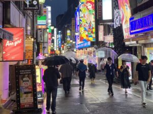 People carrying umbrellas in Tokyo during rain