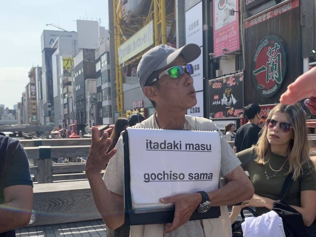 Guide on the Free Walking Tour in Osaka teaches guests some Japanese words - itadaki masu and goshiso sama