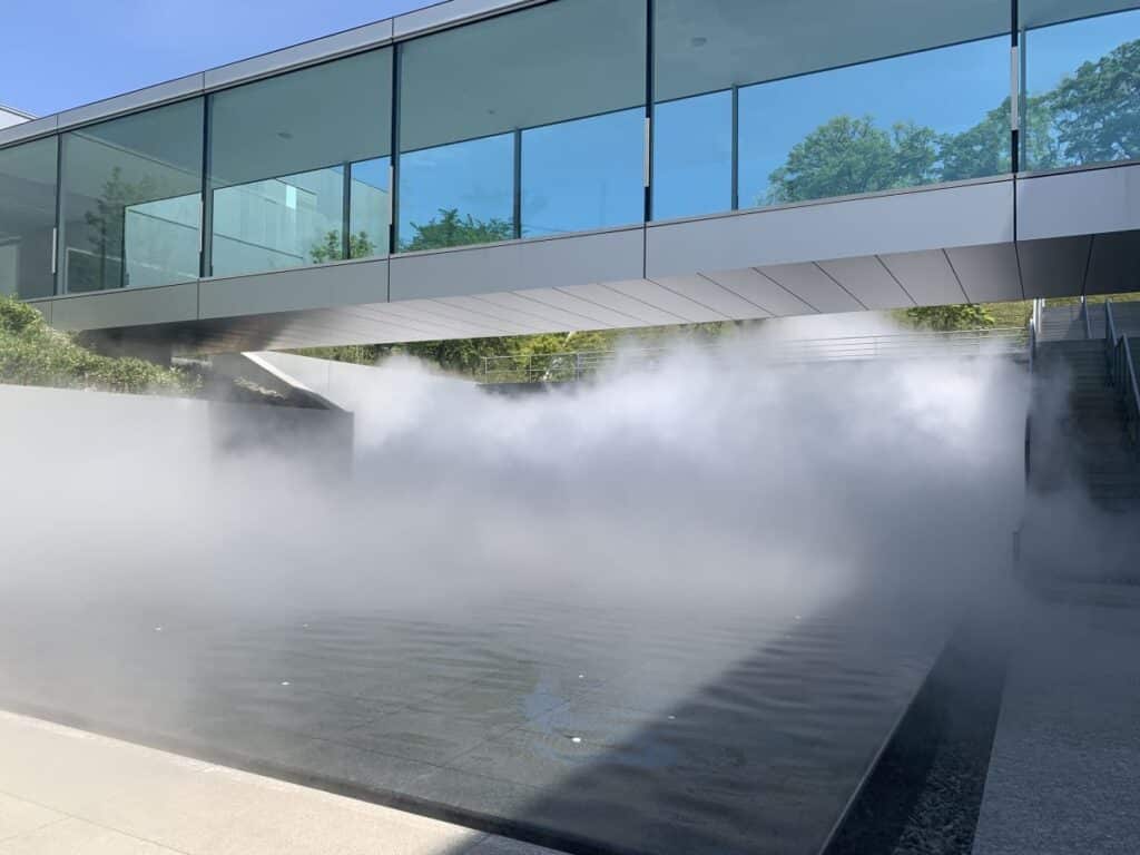 fog spills out from underneath the art museum in Nagano filling the space around it