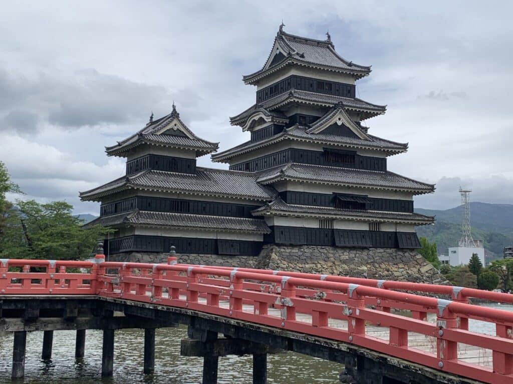 Matsumoto's black castle with the red bridge in front of it
