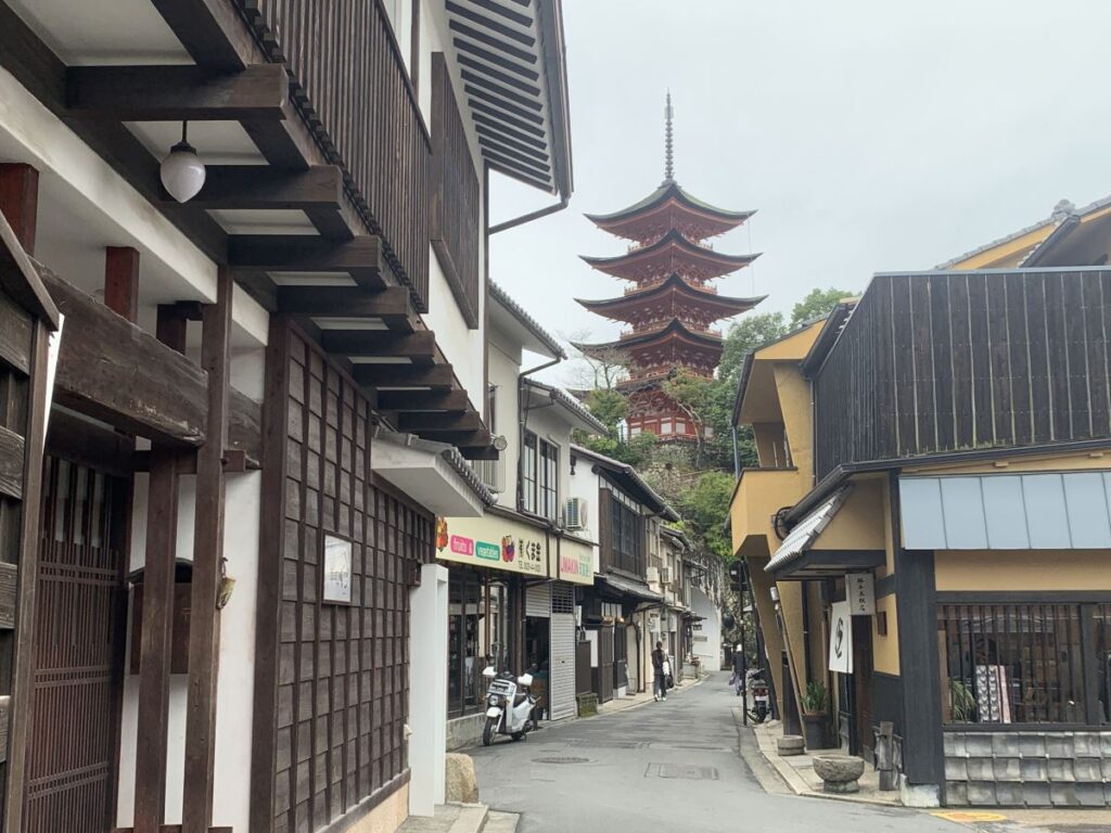Backstreets of Miyajima showing a towering pagoda in the distance