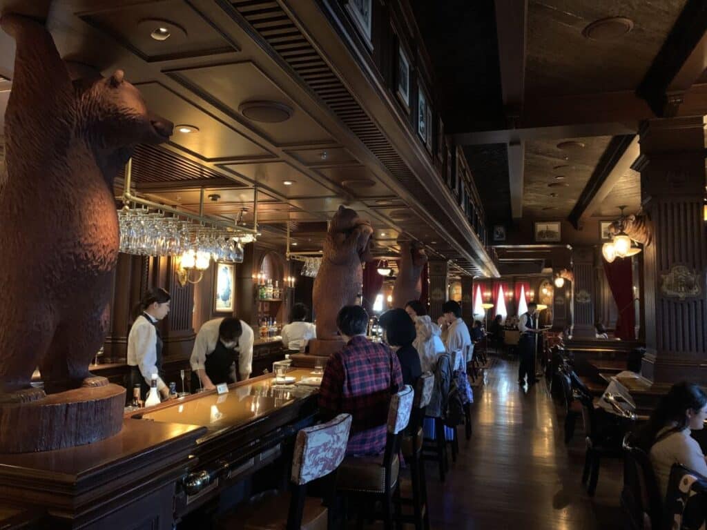 people sit at the bar on the SS Columbia in DisneySea