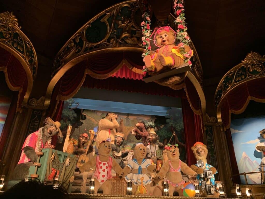 Animatronic bears swing on a swing and sing songs at the Country Bear Jamboree