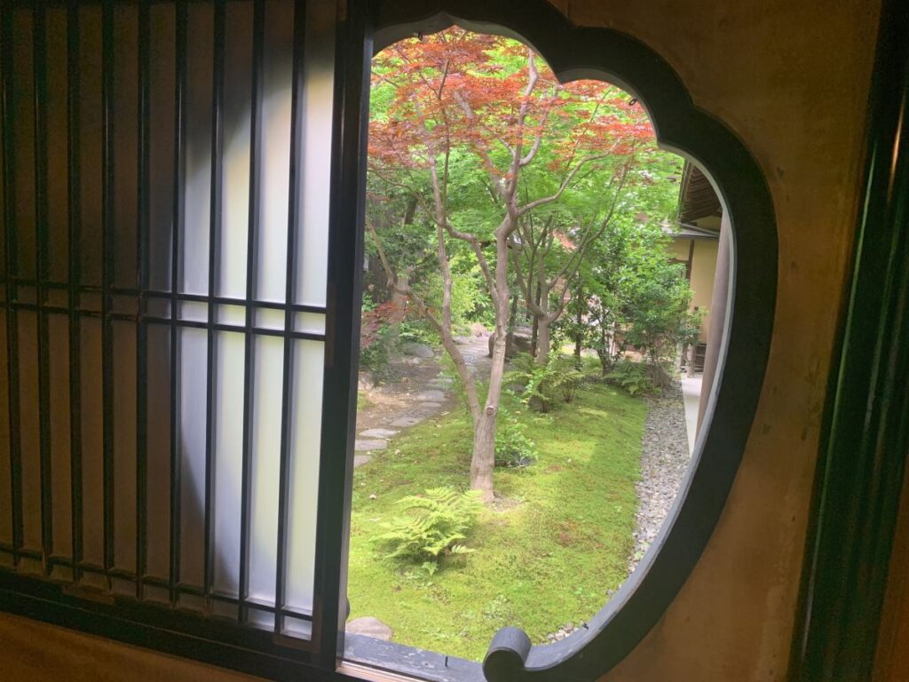 Scalloped window looks out into a pretty garden at the Naramachi Nigiwai-no-le, old merchants house