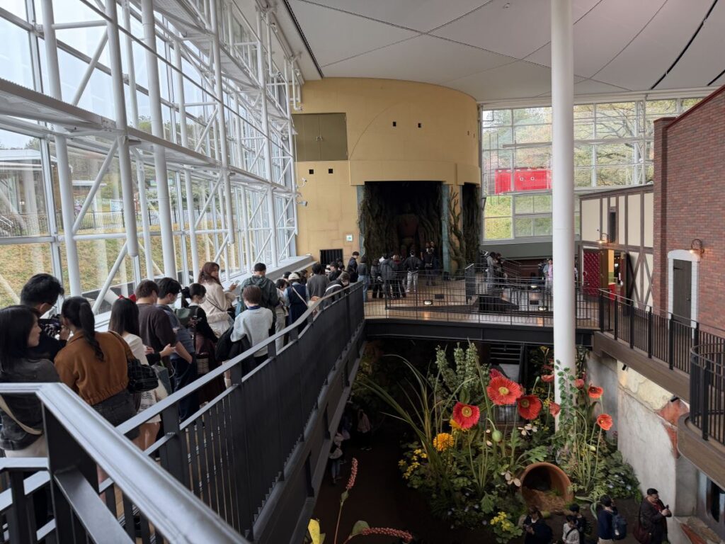The queue for a picture with the robot from Castle in the Sky at Ghibli Park