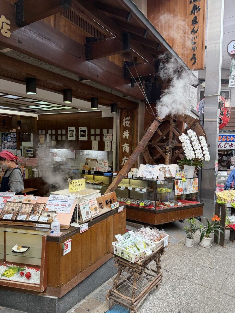 Steam comes out of a pipe cooking dumplings in Atami main street