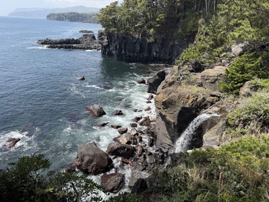 waterfall falls into the sea over volcanic cliffs on the Izu Peninsula