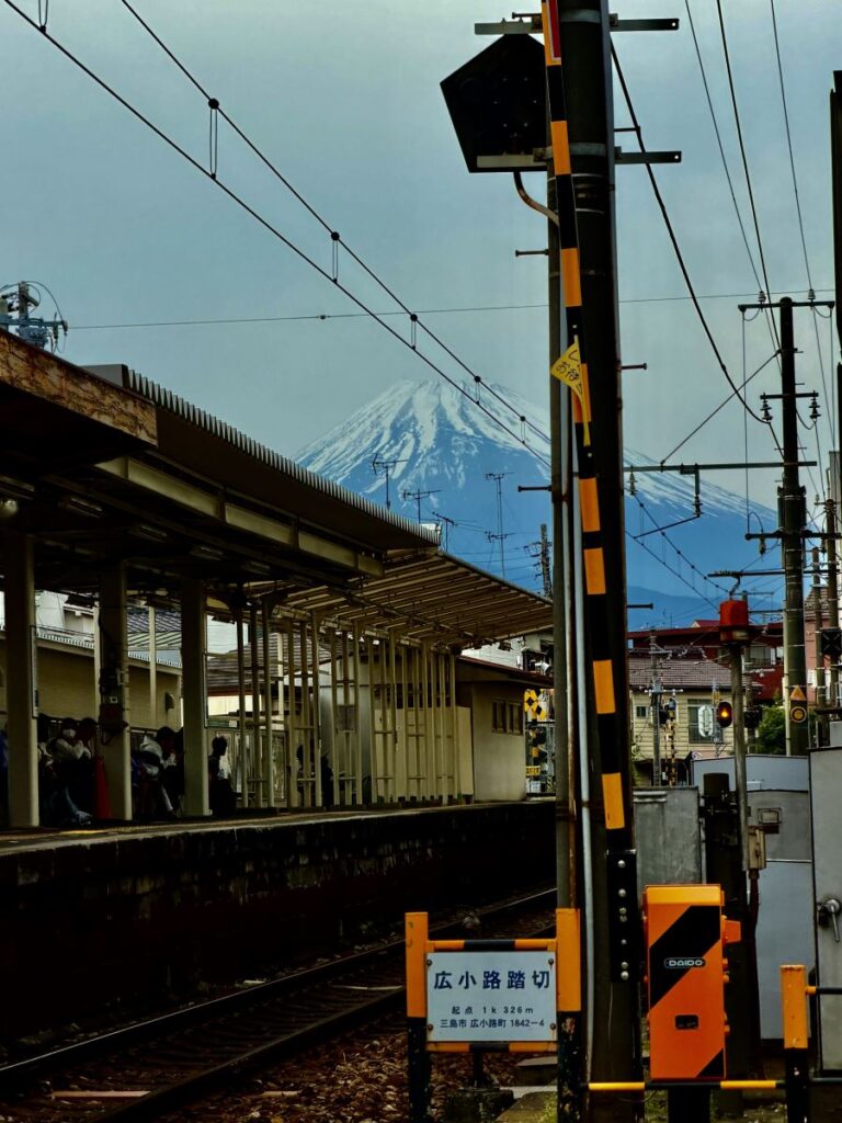 Mount Fuji towers over a small station in Mishima
