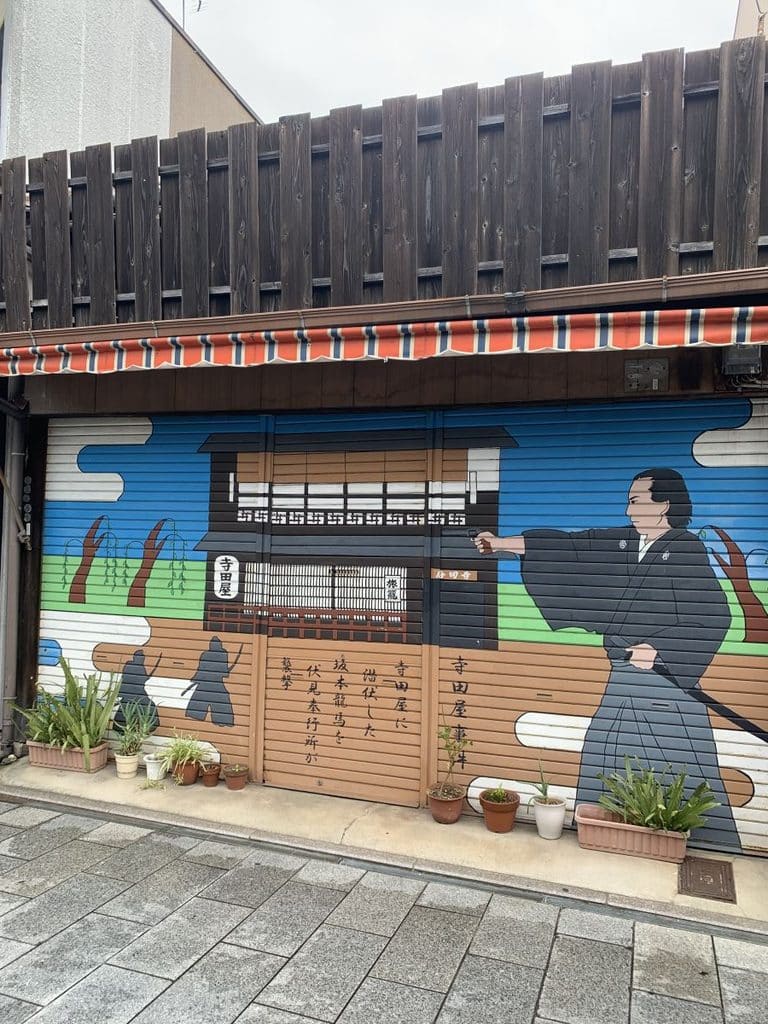 Mural in Ryoma Shopping Street showing a samurai with his sword