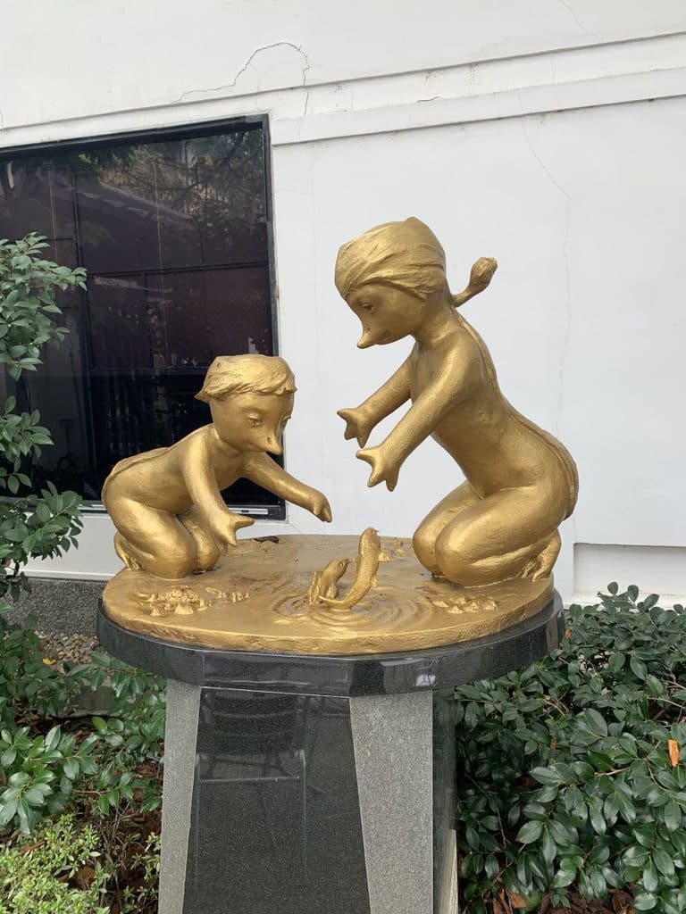 Gold kappa statues outside the Kizakura Sake company in Fushimi