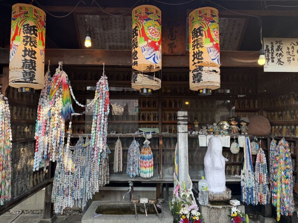White paper covered Jizo sits in a shrine in Nagoya