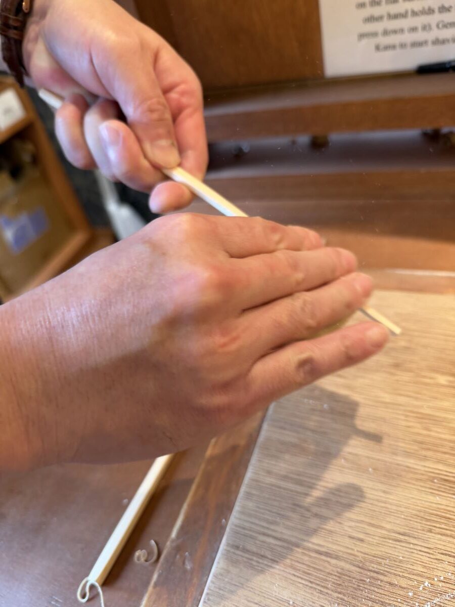 Teacher in the Asakusa Chopsticks Workshop demonstrates sanding the chopsticks