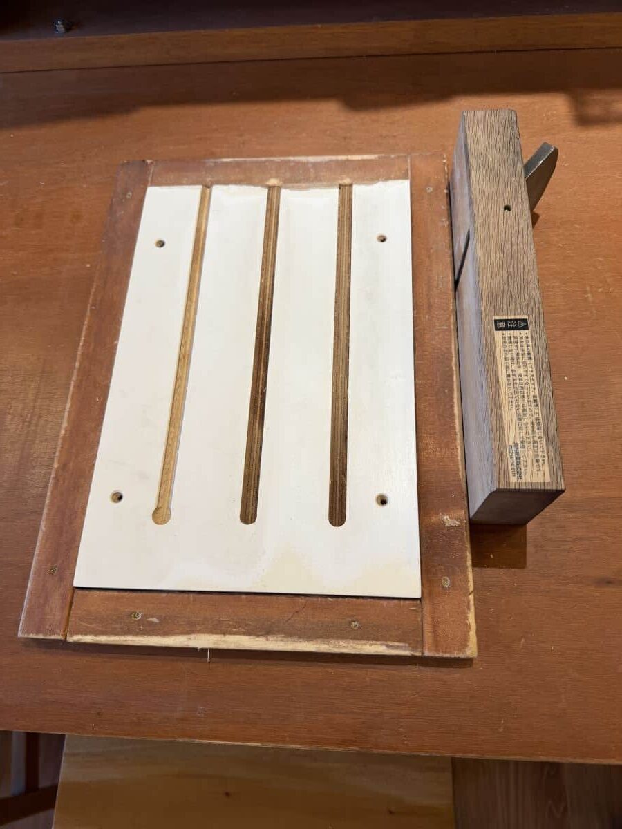 three slots in a board allow you to position the chopsticks to allow the correct amount of wood is shaved away