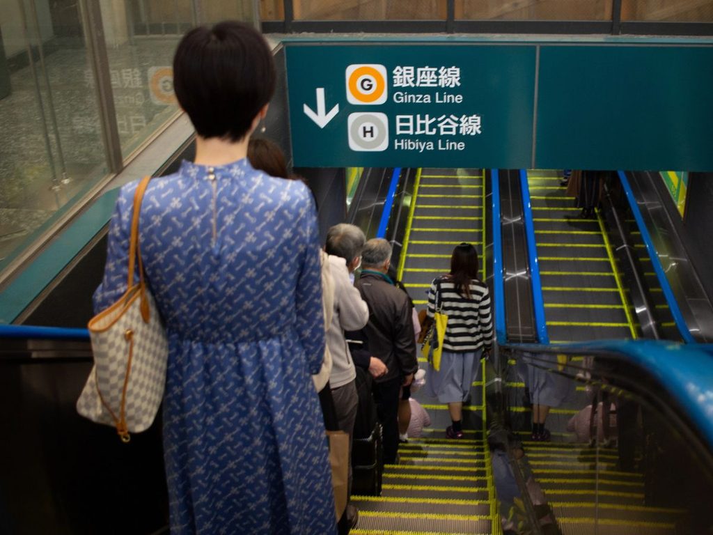 people on escalator in Tokyo