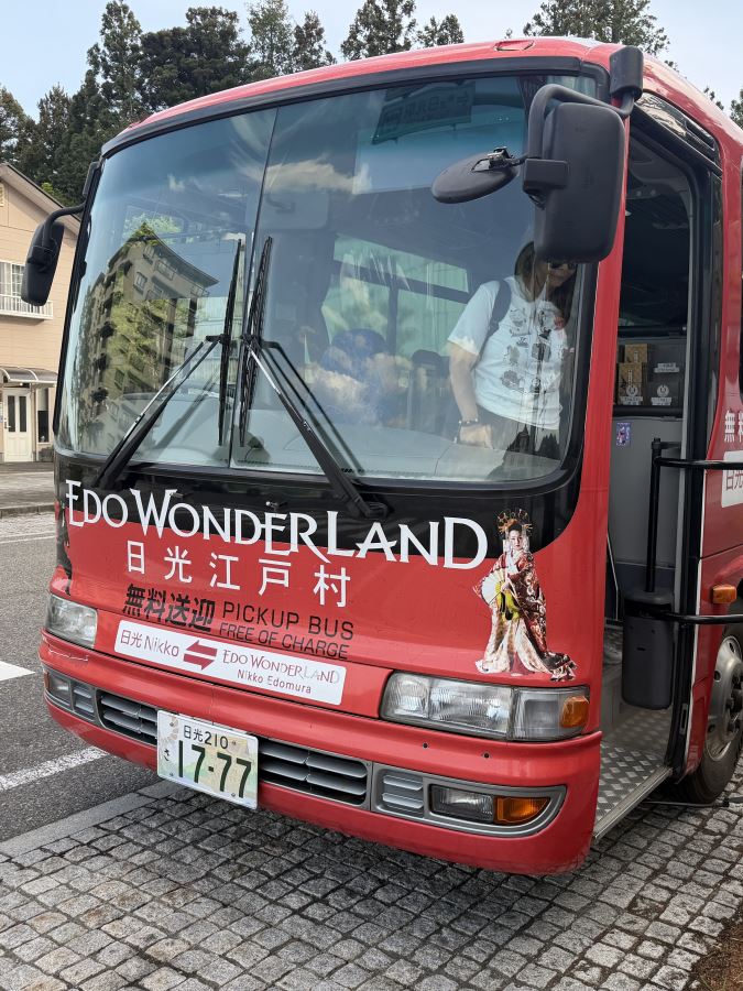 Shuttle Bus that runs from Nikko to Edo Wonderland and back. It's a red bus with Edo Wonderland on the front.