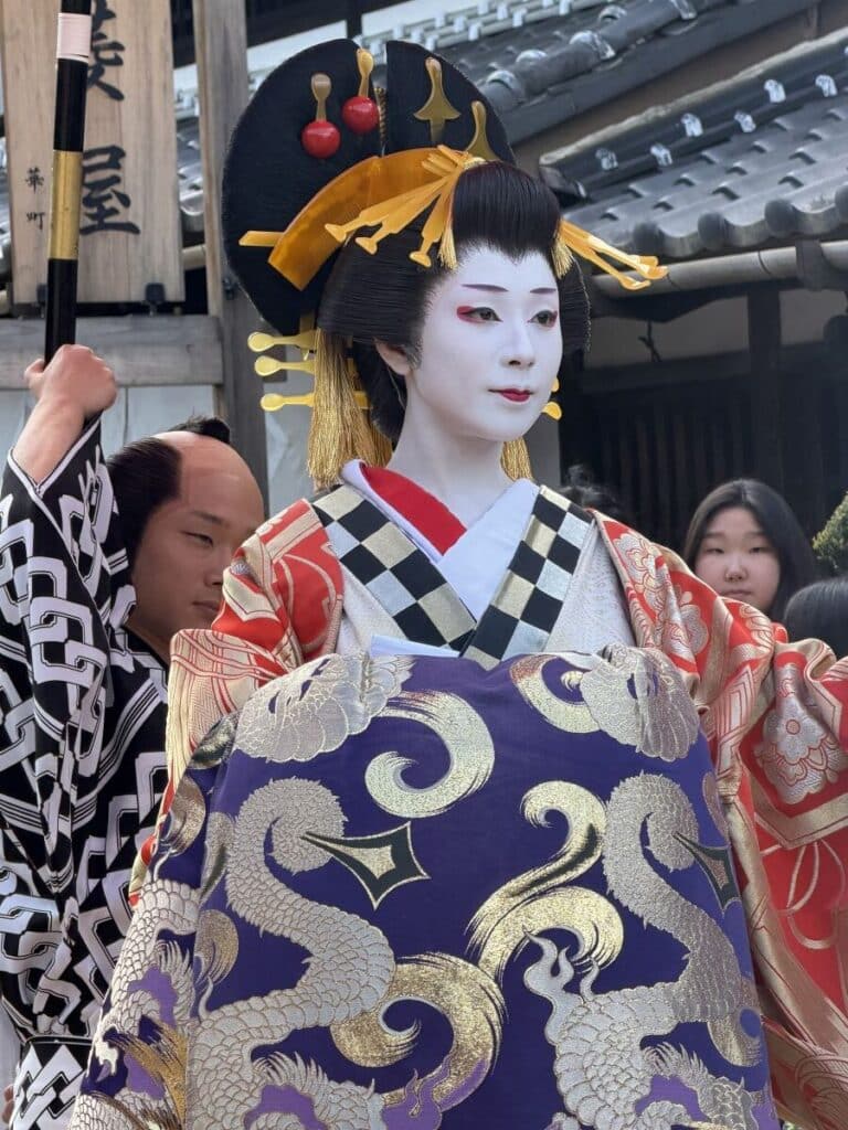 Close up showing the white face make up and hair piece of the oiran at Edo Wonderland